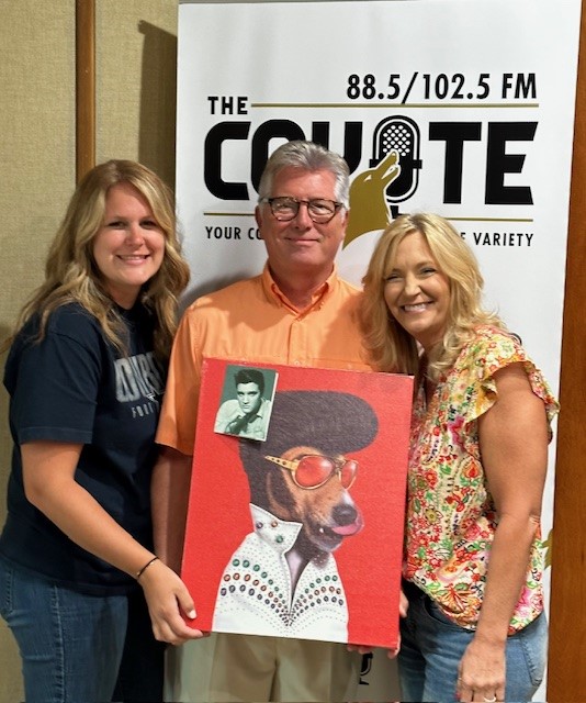Kirstie Smith and Jennifer Bledsoe with the Parker County Senior Center present Dave Cowley with a priceless piece of art on Elvis’ birthday!