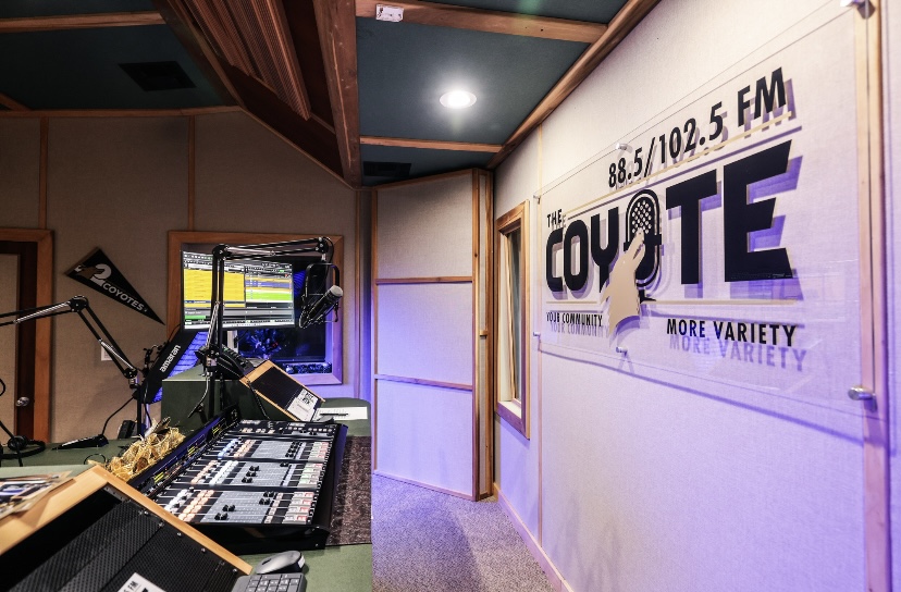 Coyote Radio logo in studio and part of sound board