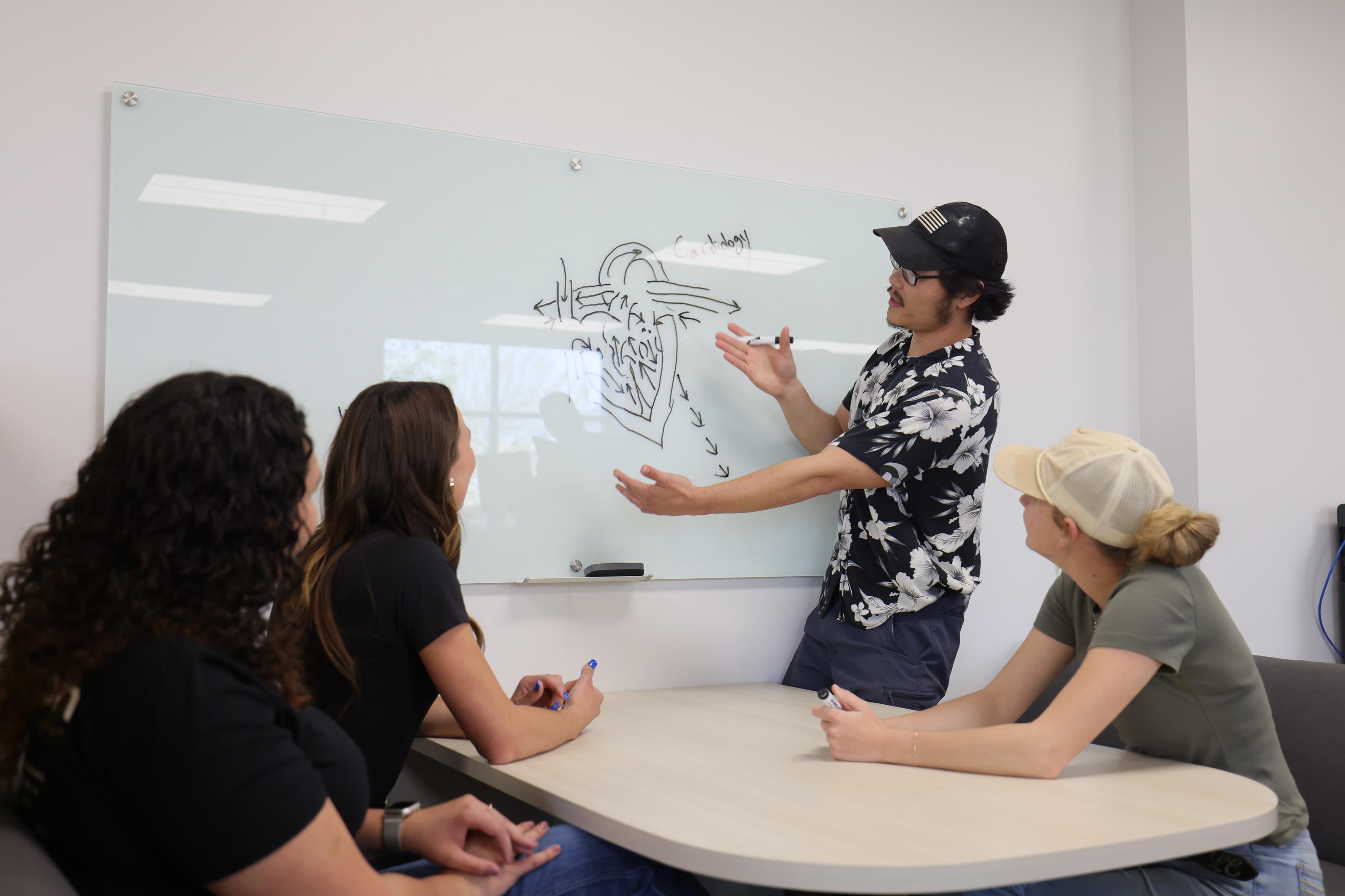 students in study session at dry erase board